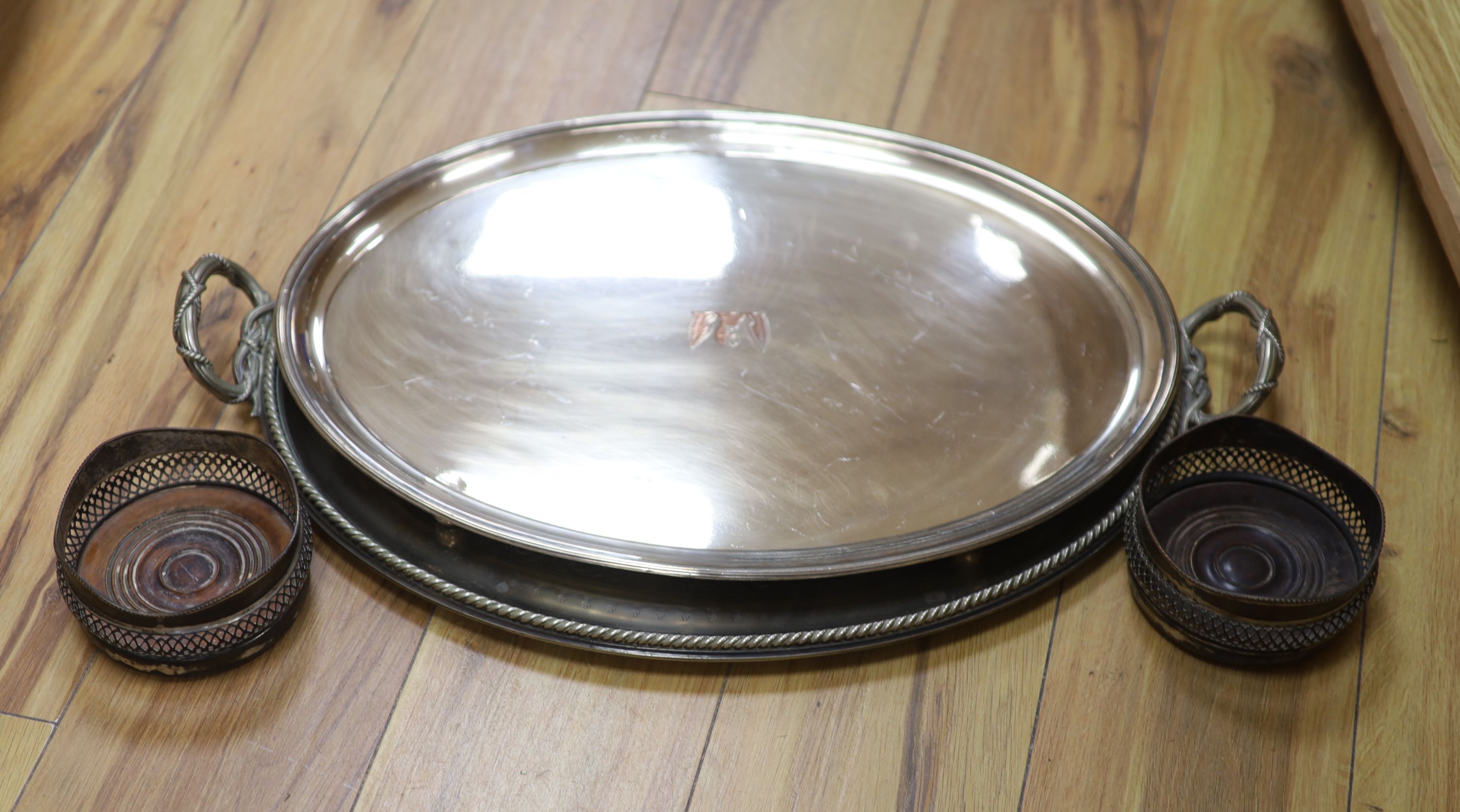 A pair of plated coasters, an oval salver and a tray